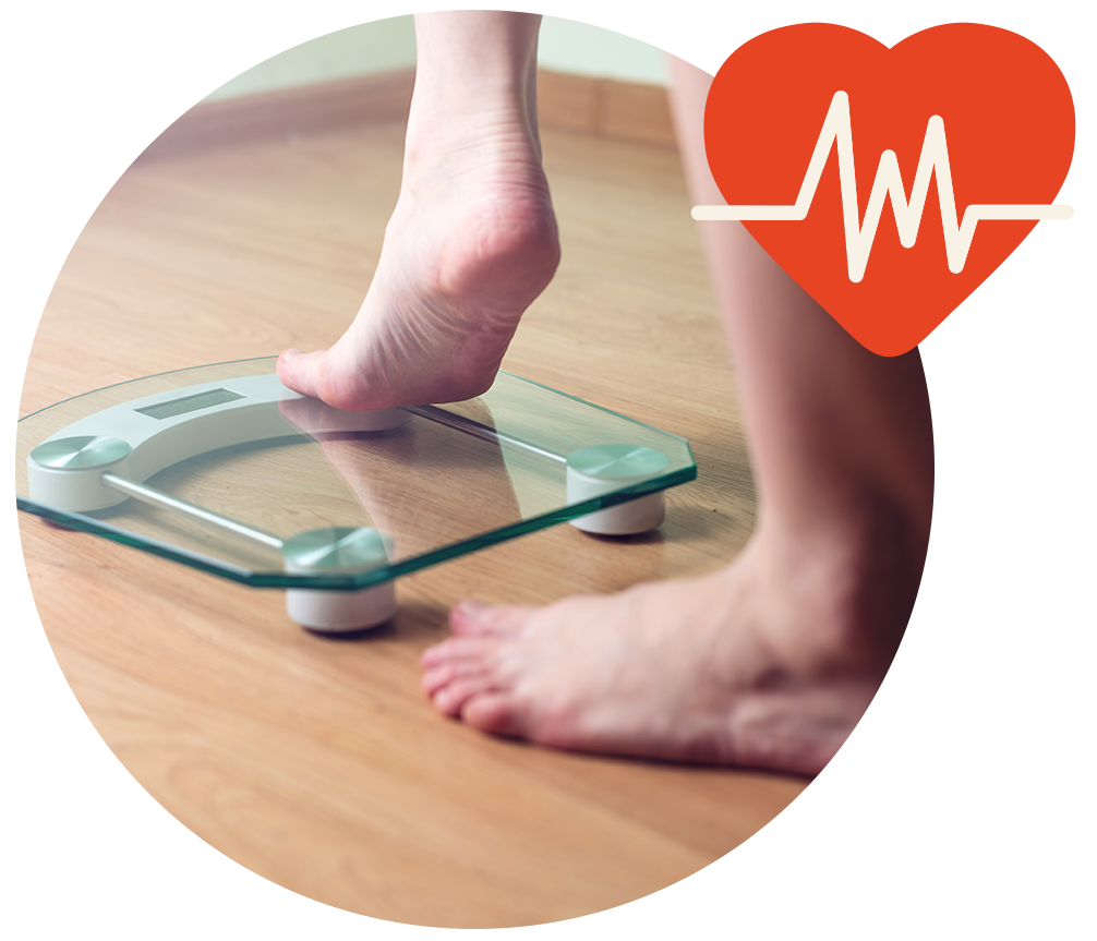 Two bare feet with one stepping on a weight scale Two bare feet with one stepping on a weight scale