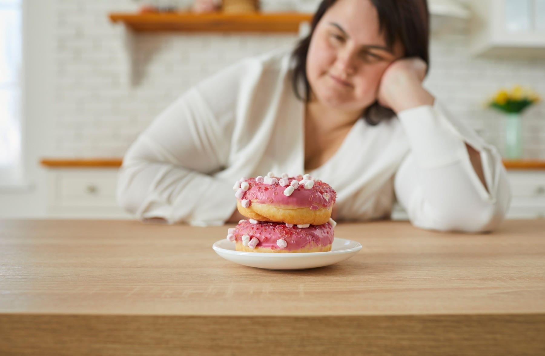 Woman struggles with tempting food